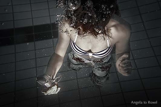 Fotografie: Junge Frau macht unter Wasser ein Selfie, Selbstportrait einer Frau unter Wasser, Unterwasserfotografie im Pool, Aufnahme von oben