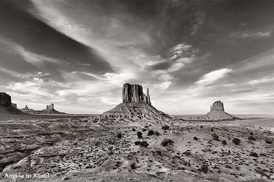 Monument Valley, Schwarzweißaufnahme, mit Sentinel Mesa, West Mitten Butte und East Mitten Butte am Abend, monochrom