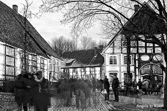 Menschen auf dem Weihnachtsmarkt, Langzeitbelichtung mit Bewegungsunschärfe, schwarzweiß