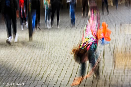 Kunstfotografie kaufen: Clown schlägt ein Rad, im Hintergrund Passanten, Bewegungsunschärfe, Wischtechnik, Bielefeld | Ihr Kontakt: Angela to Roxel