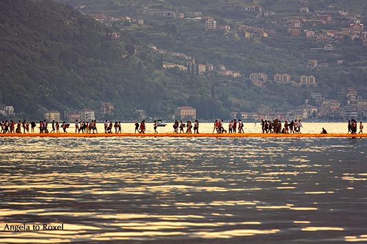 Photography: The Floating Piers - Lake Iseo, People on the walkway, Christo's "The Floating Piers" in the evening light, backlight, Italy 2016