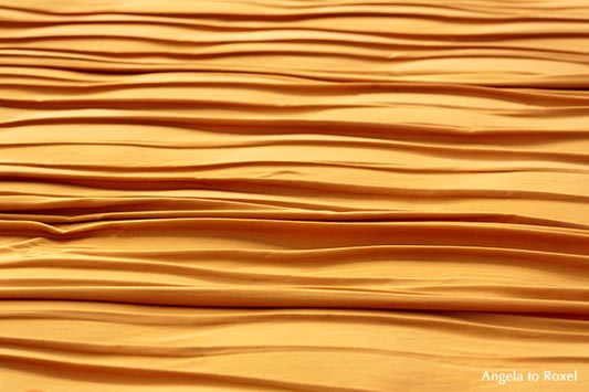 Christo's The Floating Piers, walkway made of bright yellow fabric, with shades of red and gold in sunlight -  Lake Iseo 2016